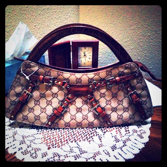 Light brown monogram Gucci handled clutch