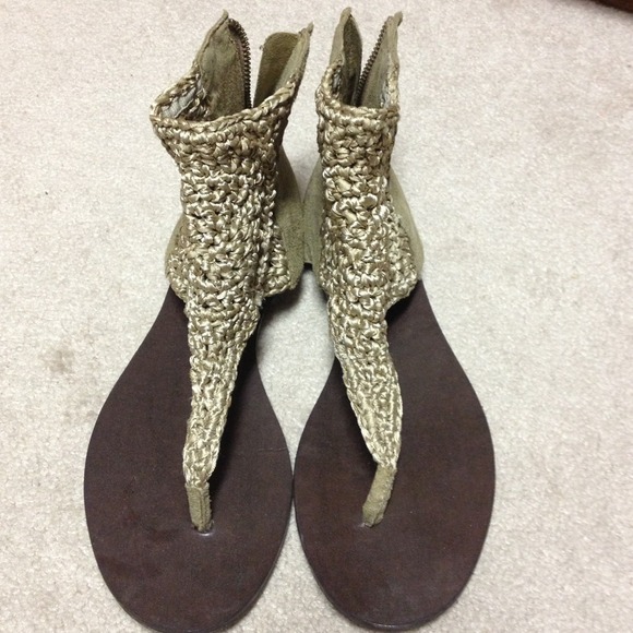 Tan crochet flat sandals with suede zipper back.