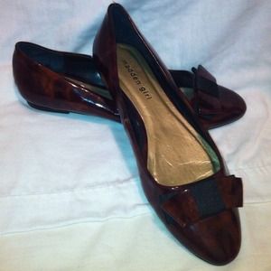 Brown flats with bow at front.
