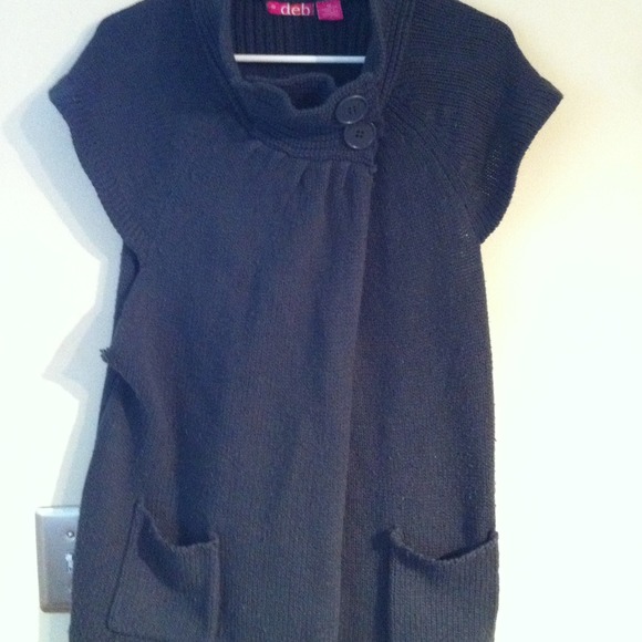 Gray sleeveless sweater and tan jacket