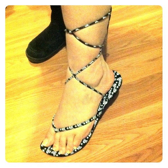 Skull and crossbones lace up flip flops