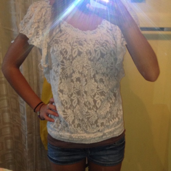 Cream colored lace shirt.