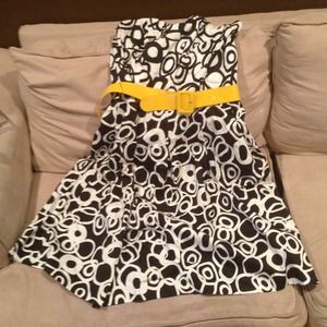 Black and white strapless dress with yellow belt.