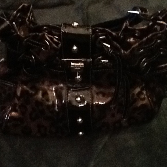 Animal print patent leather drawstring handbag.