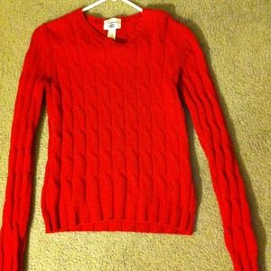 Red sweater fits more like a medium.