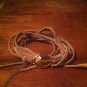 Faux suede wristlet with stone and gold accents!