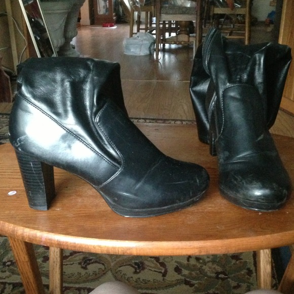 Thigh high black heeled boots.