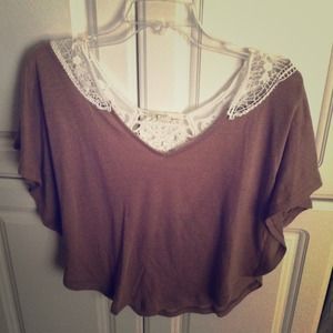 Brown, loose-fit top with a white lace design.