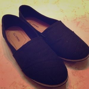 Black shoes similar to Toms.
