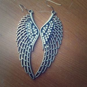 Dangling, silver angel wing earrings.