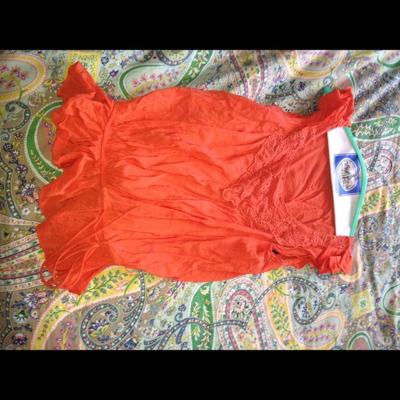 Orange ruffled sleeve top with crochet lace