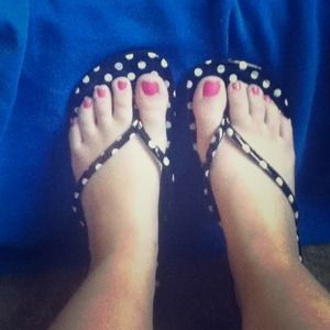Black and white polka dot flip flops