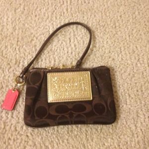 Small coach wrist clutch