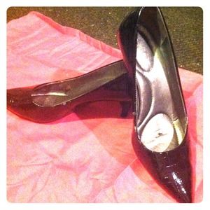 Black patent kitten heels with snake skin design.