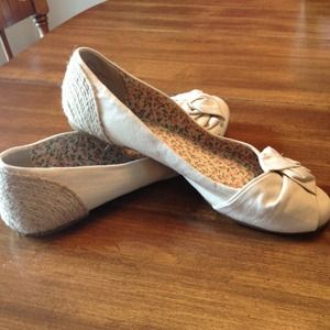 Cute beige flats with straw trim around the heel