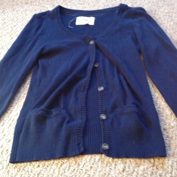 Navy blue sweater bundled with cnsfts book