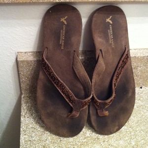Dark brown suede flip flops with beaded thong
