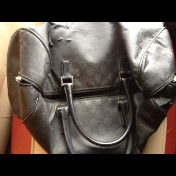 Black Gucci duffle bag.