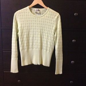 A light, pastel green sweater.