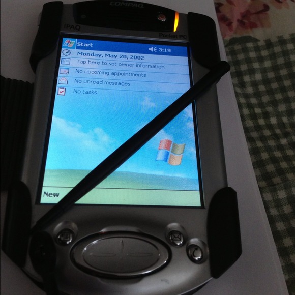 Compaq pocket pc with case, charger and stylus.