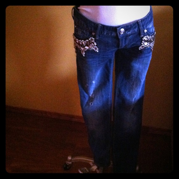 Distressed denim with side pocket crystal detail.