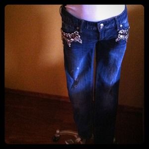 Distressed denim with side pocket crystal detail.