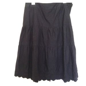 Tiered black skirt with eyelet hem