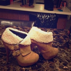 A pair of ankle high boots worn  once