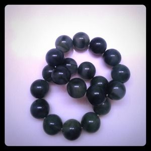 2 green colored stretchy bracelets