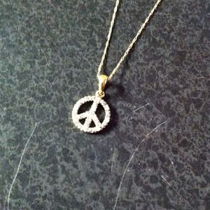 Diamond and gold peace sign necklace