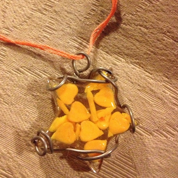Yellow and clear star shaped pendant on necklace