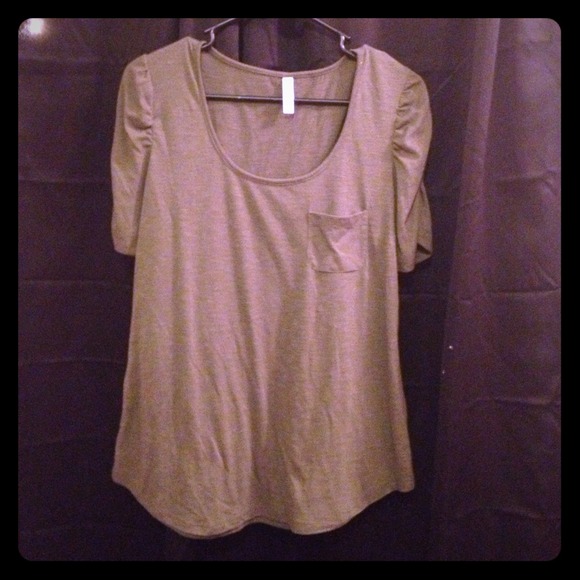 Green shirt with ruffled shoulders.