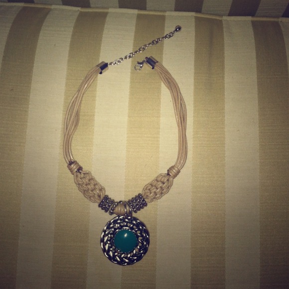 Hemp-like necklace with reversible pendant.