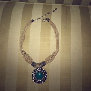 Hemp-like necklace with reversible pendant.