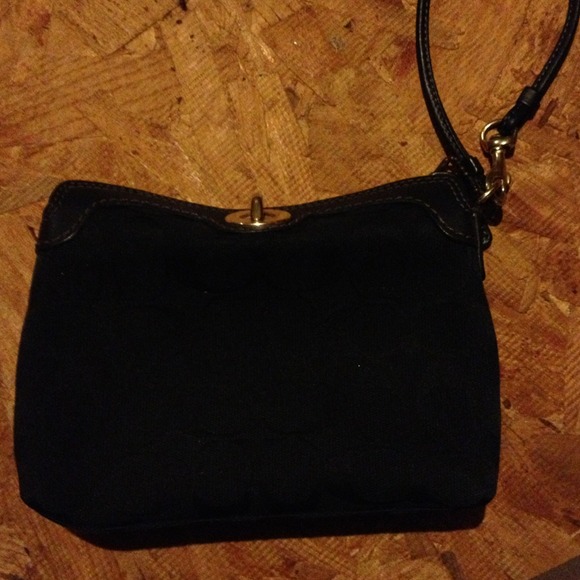 Black coach wristlet with small gold hinge