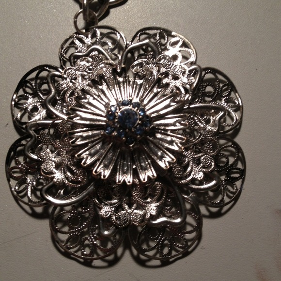 Silver flower pendant.