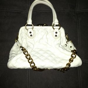 White purse with gold chain.