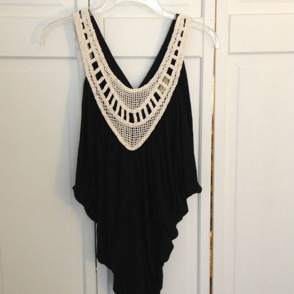 Black tank with crochet embroidery.