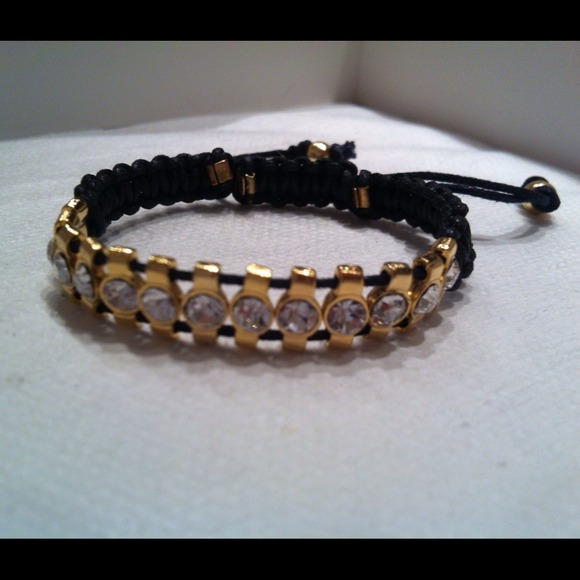 Rhinestone bracelet on black string.