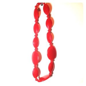 Large red plastic beaded necklace.