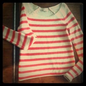 Knitted-striped, coral and ivory sweater.