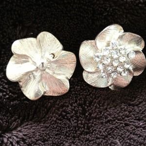 Silver embellished flower earrings.