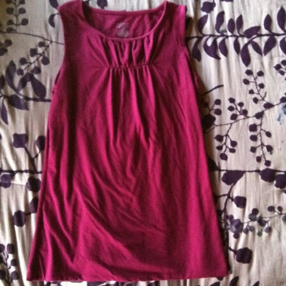 Burgundy sleeveless shirt.
