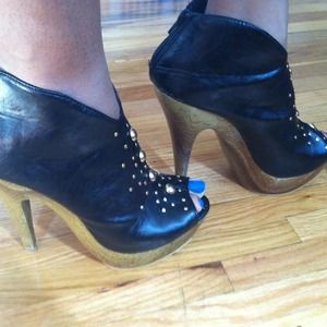 Black leather Bootie with gold studs.