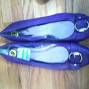 Purple flat shoes with silver buckle.