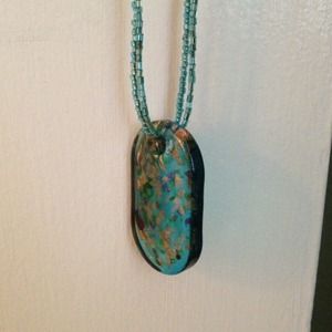 Glass medallion necklace.