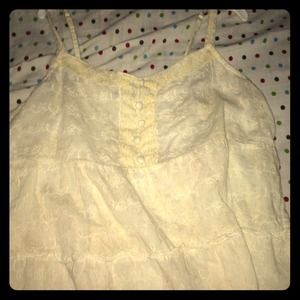 Cream colored sheer tank top with flower detail