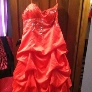 A beaded coral strapless prom dress