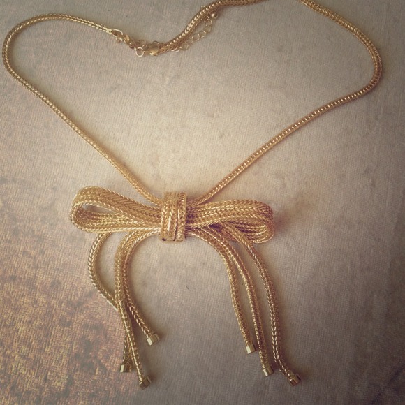 Gold bow necklace.