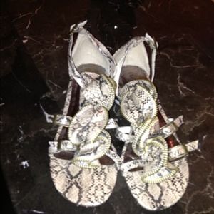 Snake like leather sandals.